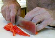 Lynn cutting a red pepper